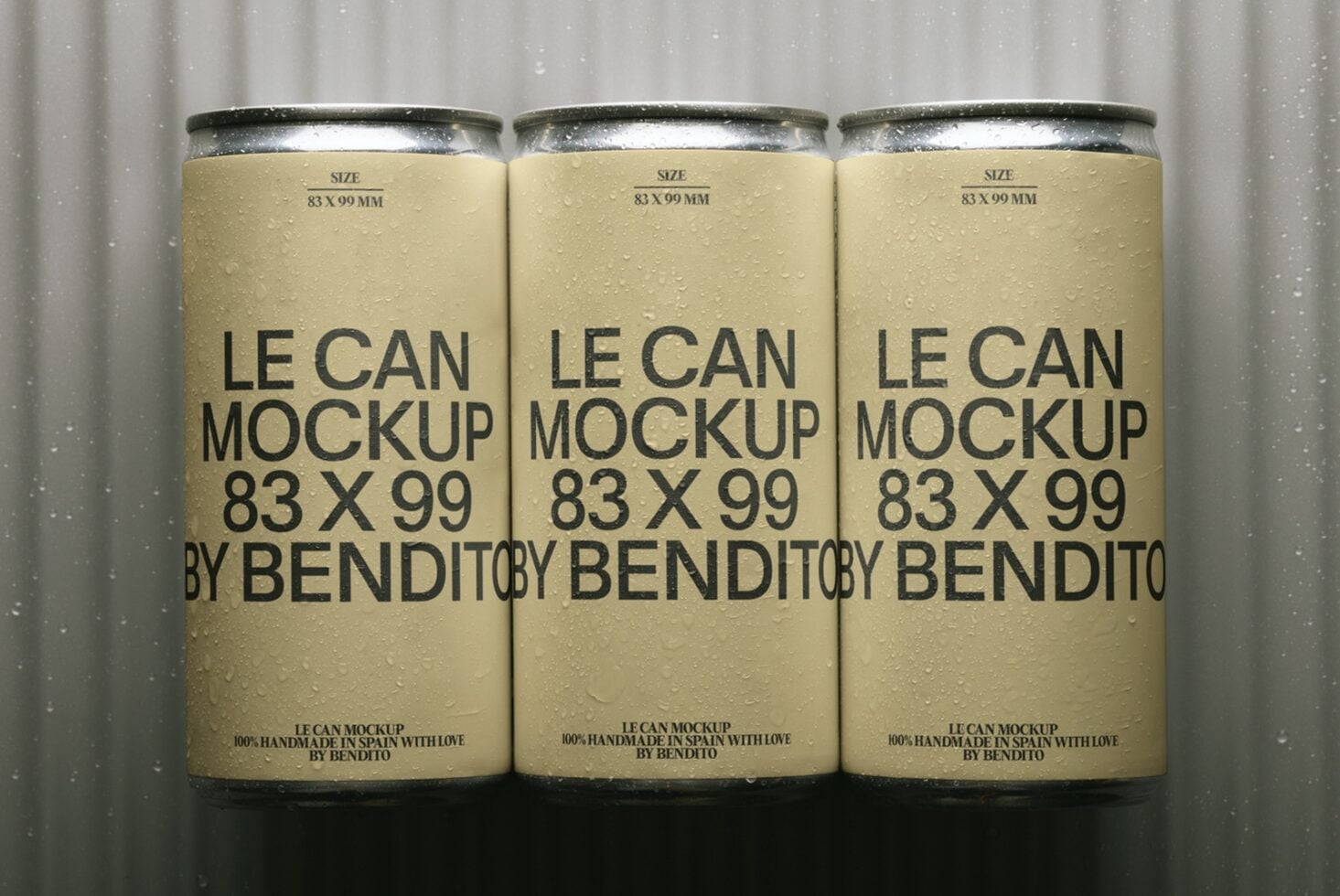 Three condensation-covered beverage cans with cream labels, black typography, metallic tops on gray background