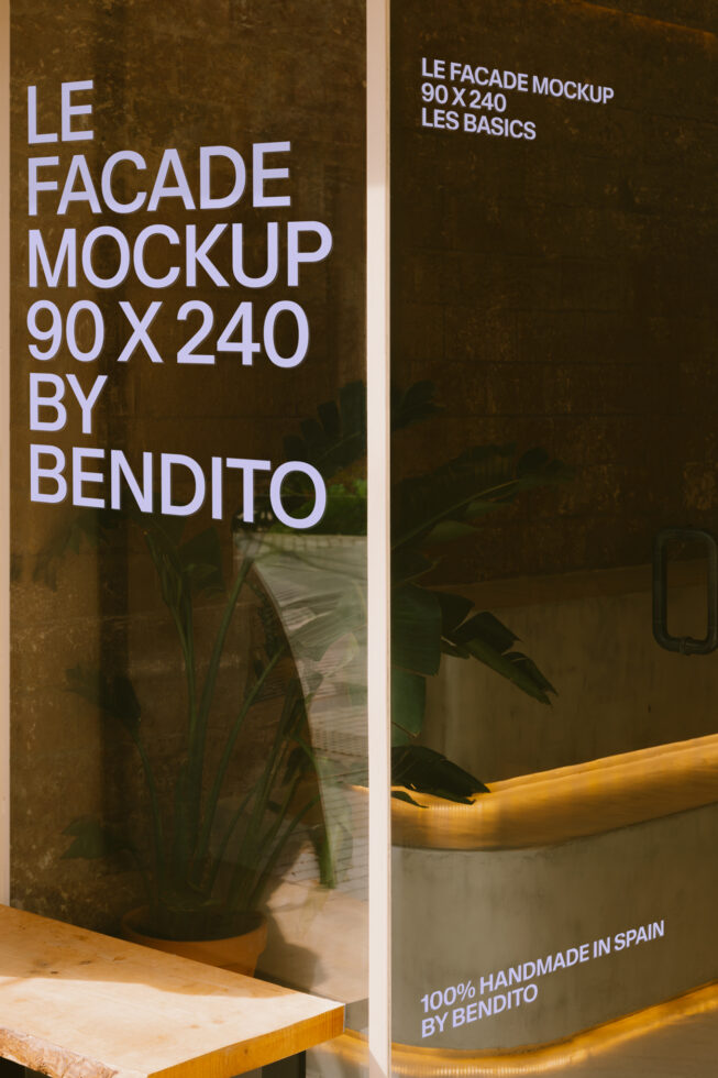 Storefront window mockup showing white sans-serif text on aged ochre wall with plants, wooden shelf, warm lighting
