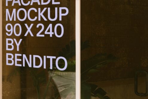 Building facade mockup 90x240 showing white sans serif text on earthy textured surface with plants