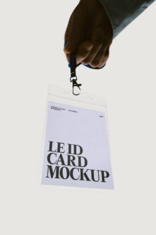 Hand holding clear ID badge with lavender card showing bold serif typography mockup