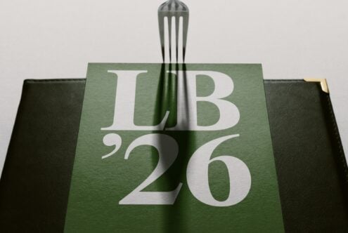Hardcover book mockup with sage green cloth cover showing LB 26 typography in white
