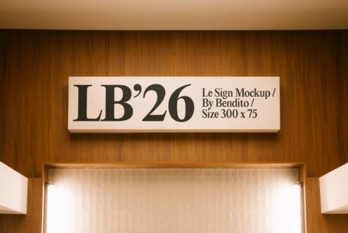 Horizontal storefront sign with serif typography mounted on warm wood paneling above doorway