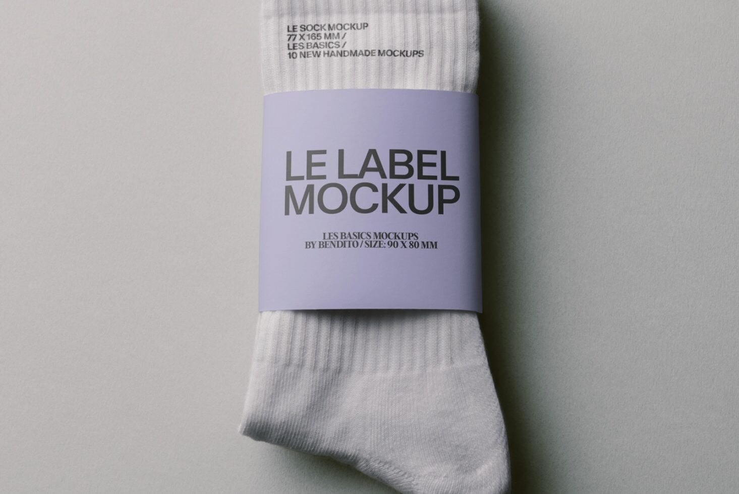 Lavender band label wrapped around white ribbed socks mockup from above