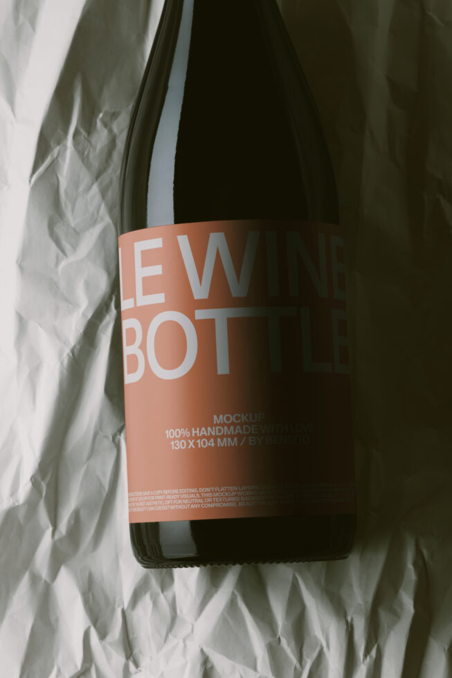 Dark glass bottle with terracotta label mockup on crinkled white fabric