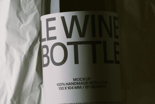 Wine bottle label mockup shot at an angle with crinkled fabric backdrop