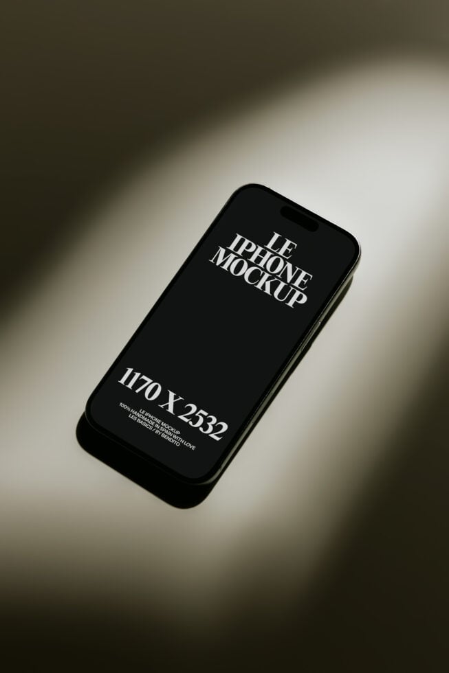 Black iPhone 12 mockup with editable screen on neutral background with dramatic shadows