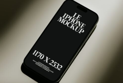 Black iPhone 12 Pro mockup with serif typography on dark screen, angled view on neutral background