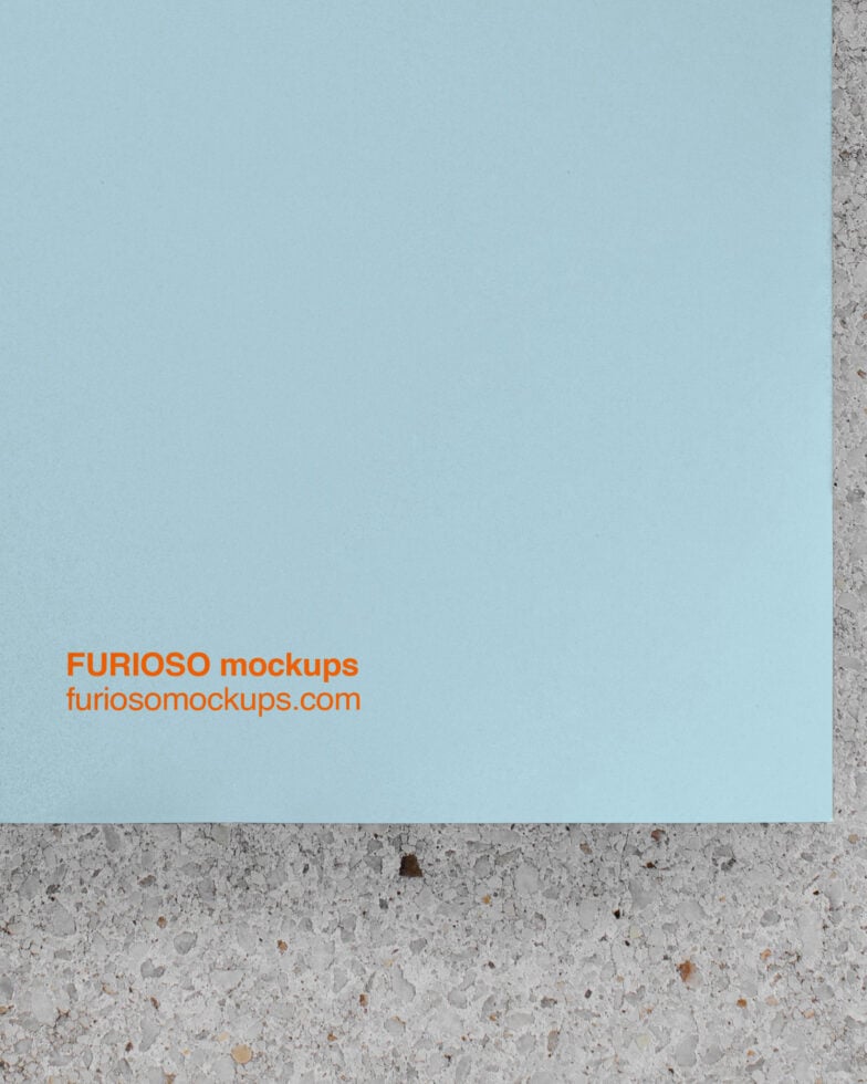 Light blue paper with orange text on concrete surface mockup
