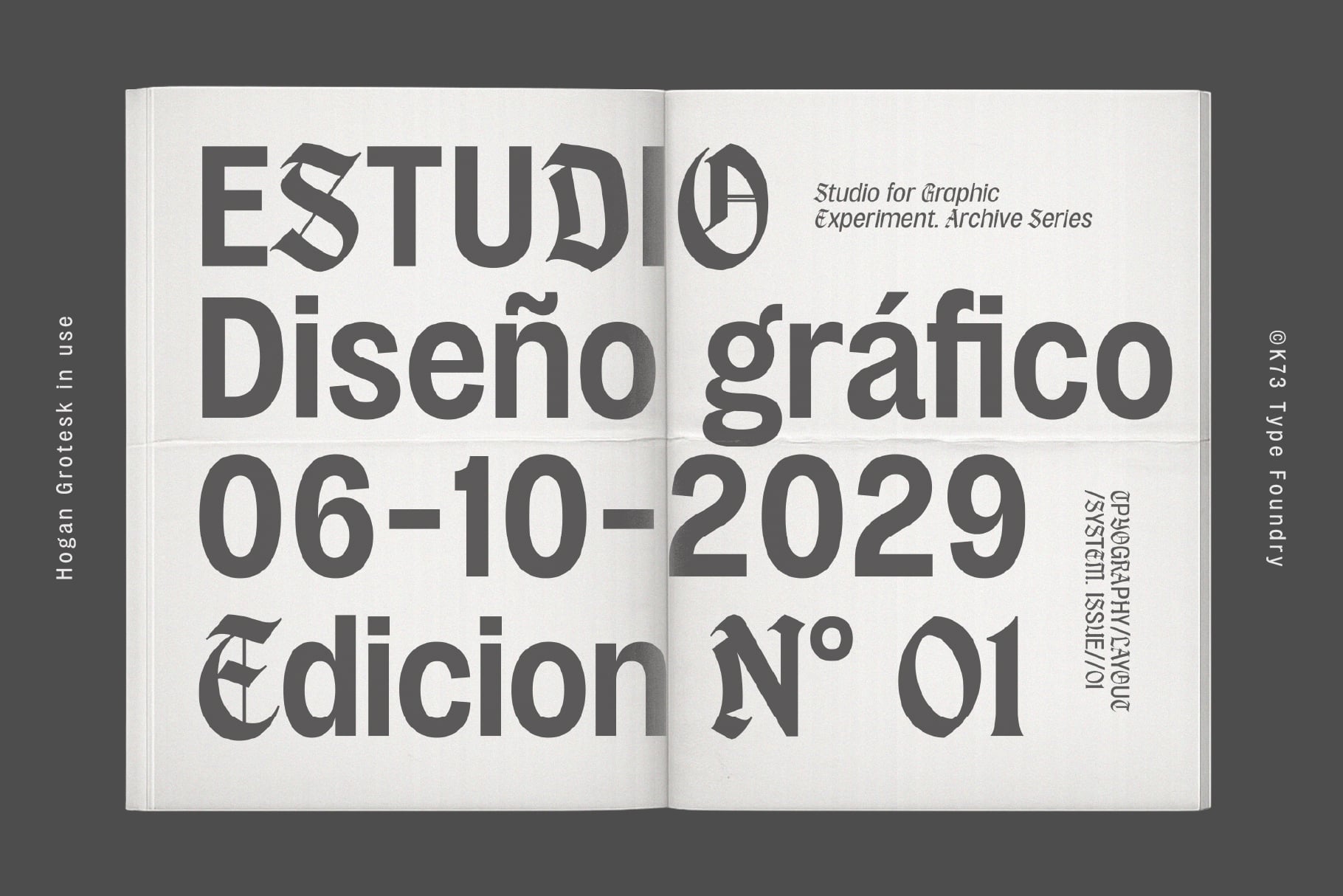 Open book spread showing bold typography layout for graphic design studio archive publication