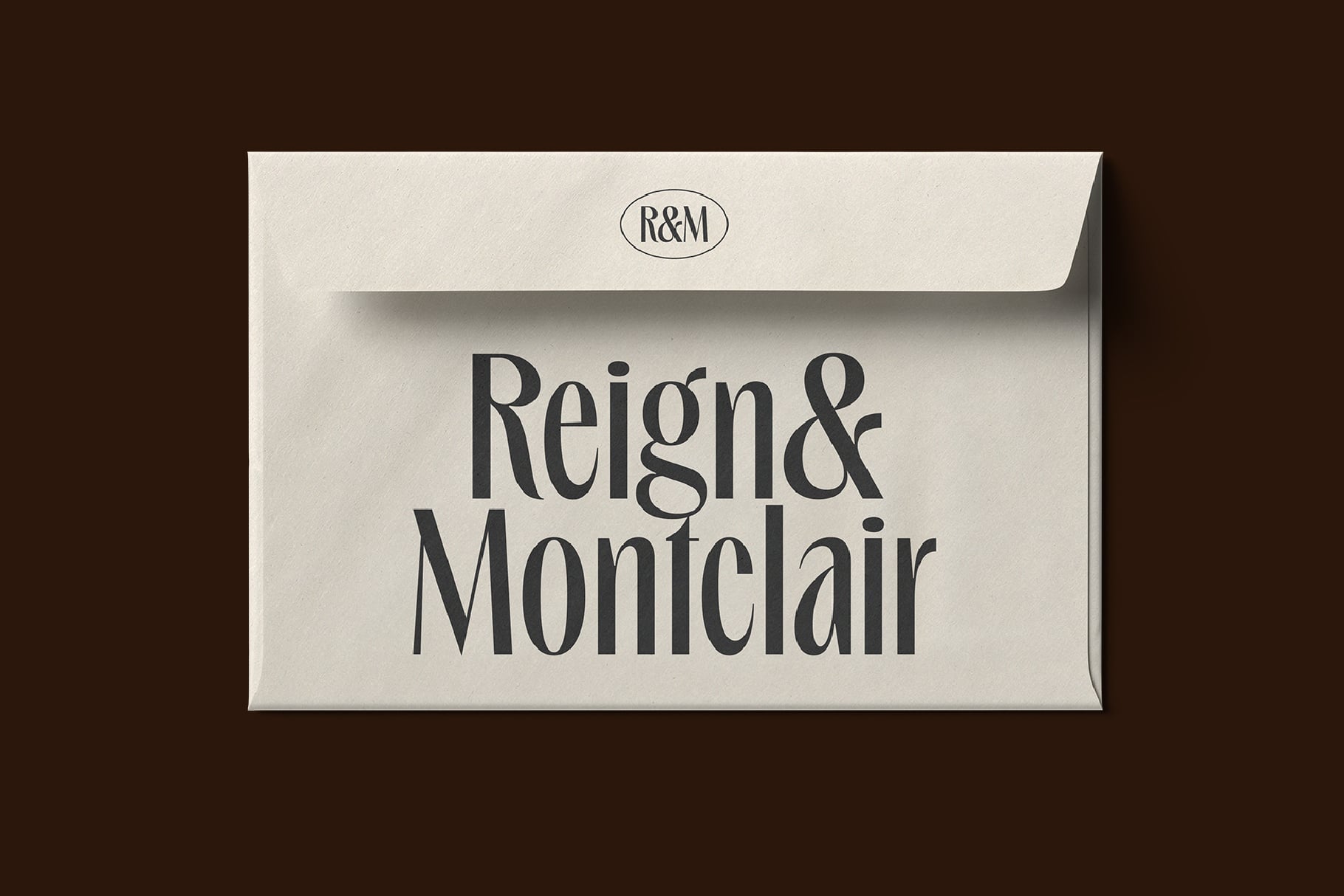 Cream envelope mockup with R&M logo showing Reign & Montclair brand branding on front