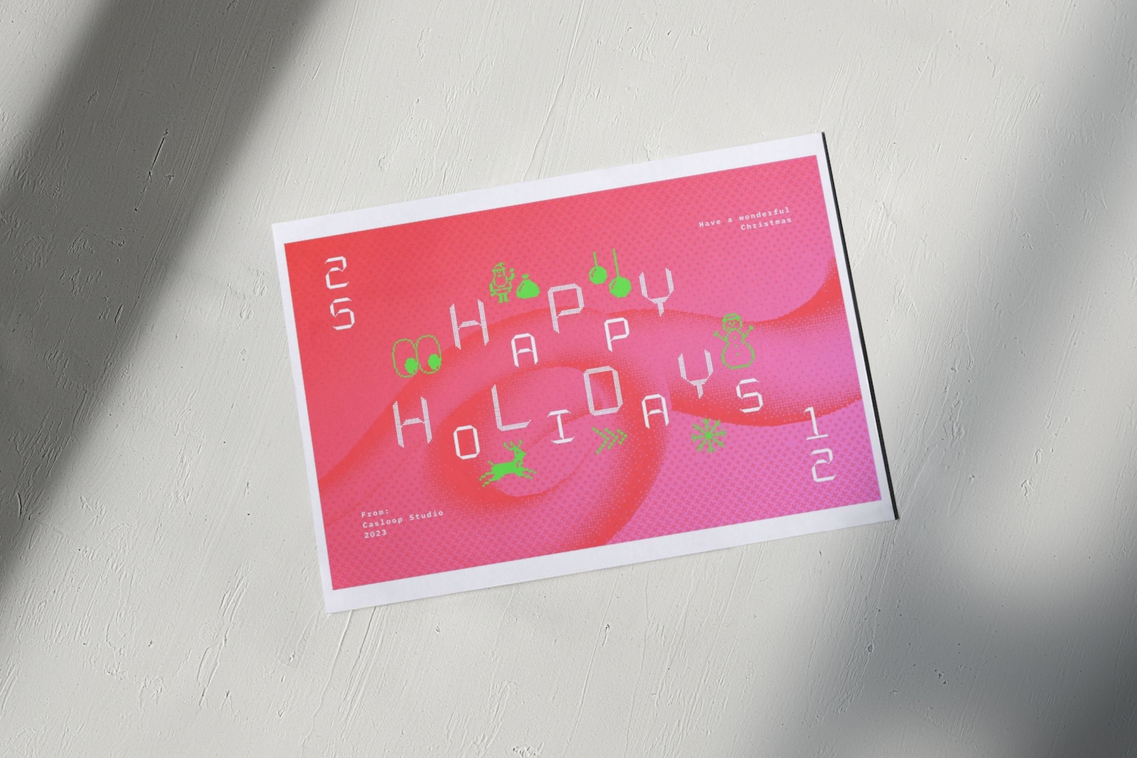 Bright pink holiday card mockup with scattered text, ornaments, pine branches on white wooden surface with shadow