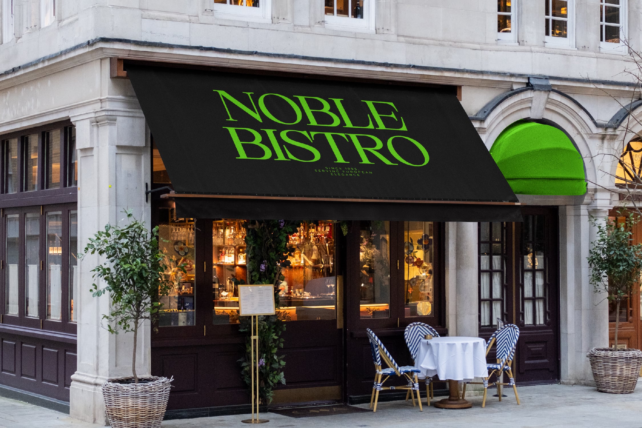 Upscale bistro storefront with neon green awning, black facade, outdoor seating