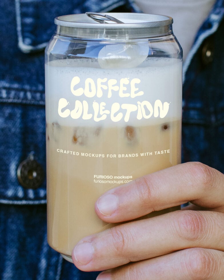 Hand holding iced coffee in glass jar with cream colored label typography mockup