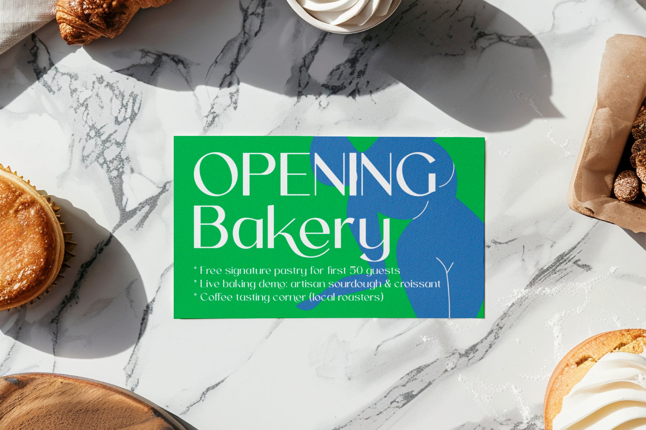 Bakery opening flyer mockup on marble surface with croissants, coffee, plus fresh pastries styled around