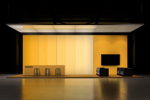 Retail storefront mockup with bold yellow walls, illuminated ceiling, bar seating, display screen