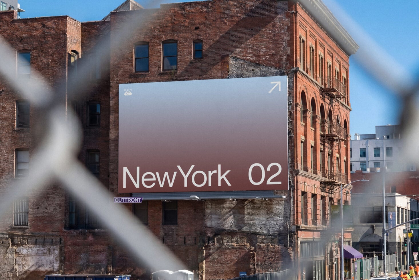 Large billboard mockup on gritty NYC brick building with gradient design showing "NewYork 02" text