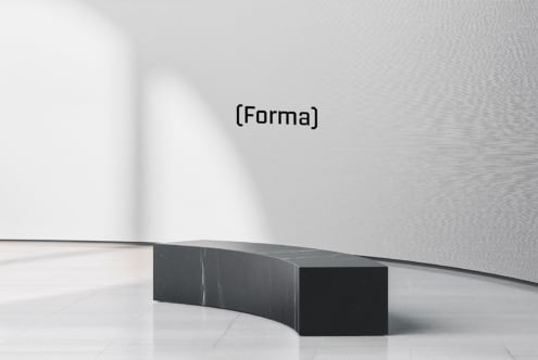 Curved black marble bench in minimal gallery space with Forma branding on wall