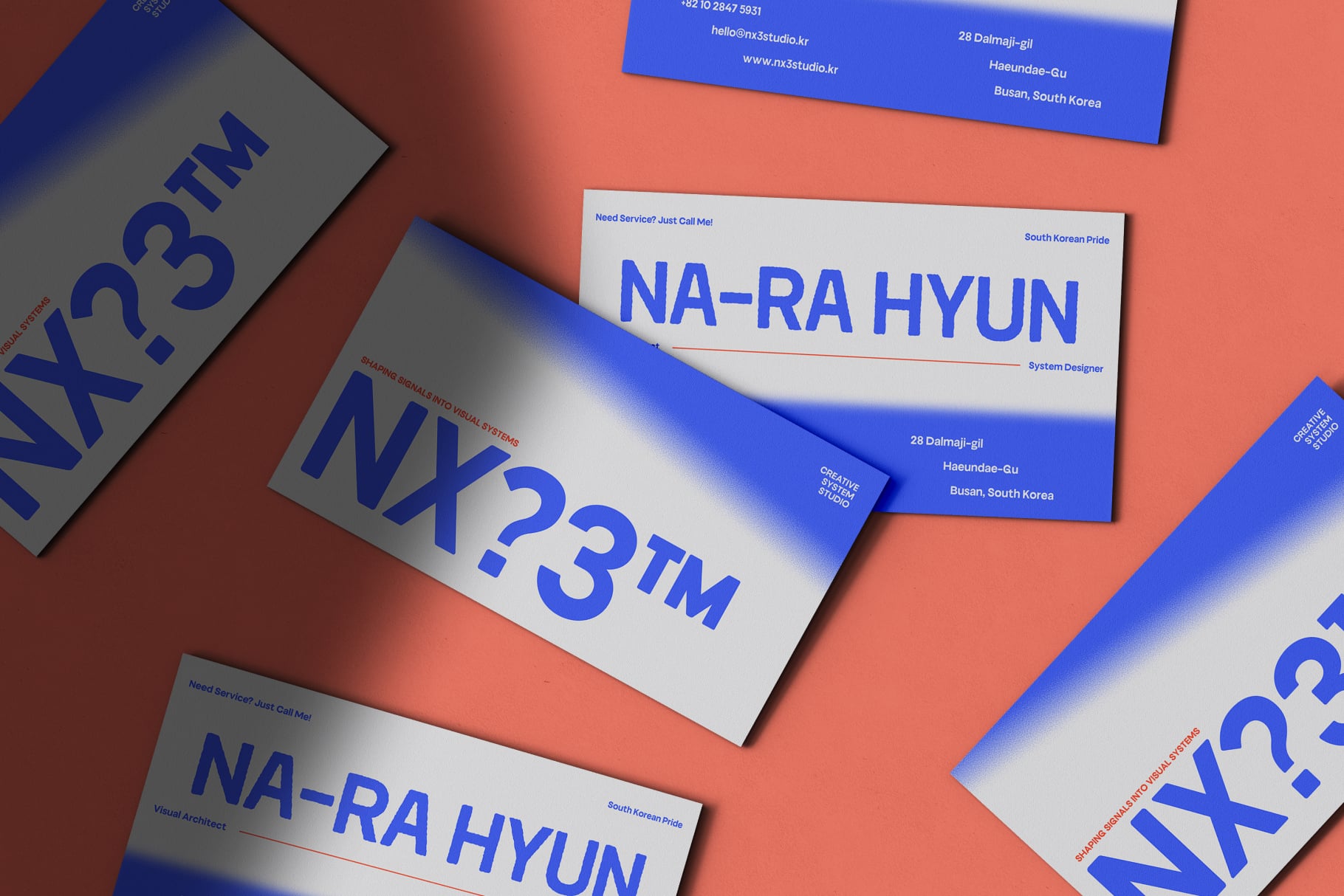 Business card mockup with bold blue typography on coral background, scattered layout
