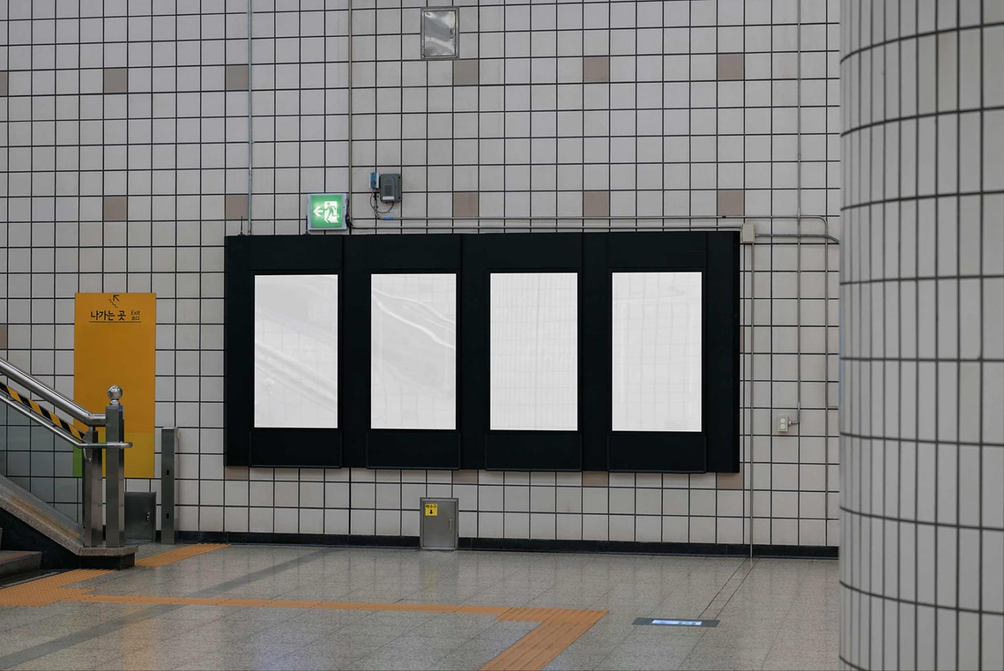 Four-panel black storefront mockup on tiled subway wall with exit sign above