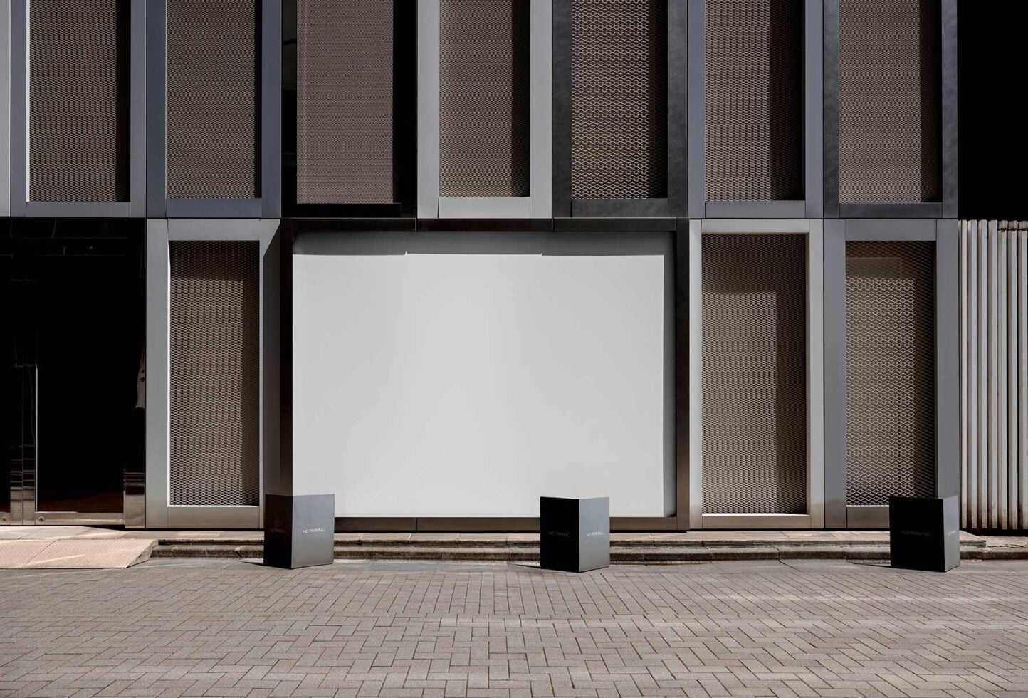 Blank storefront billboard mockup with modern building facade behind it