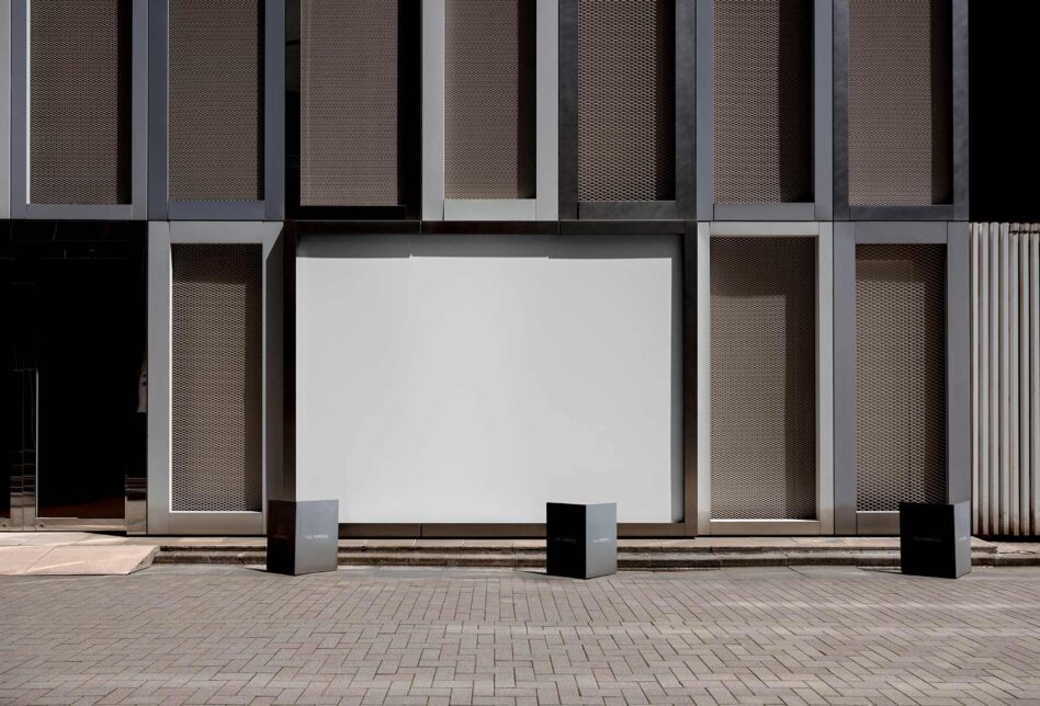Blank storefront billboard mockup with modern building facade behind it
