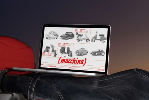 Laptop displaying car model mockups with red typography on white background, propped on black leather