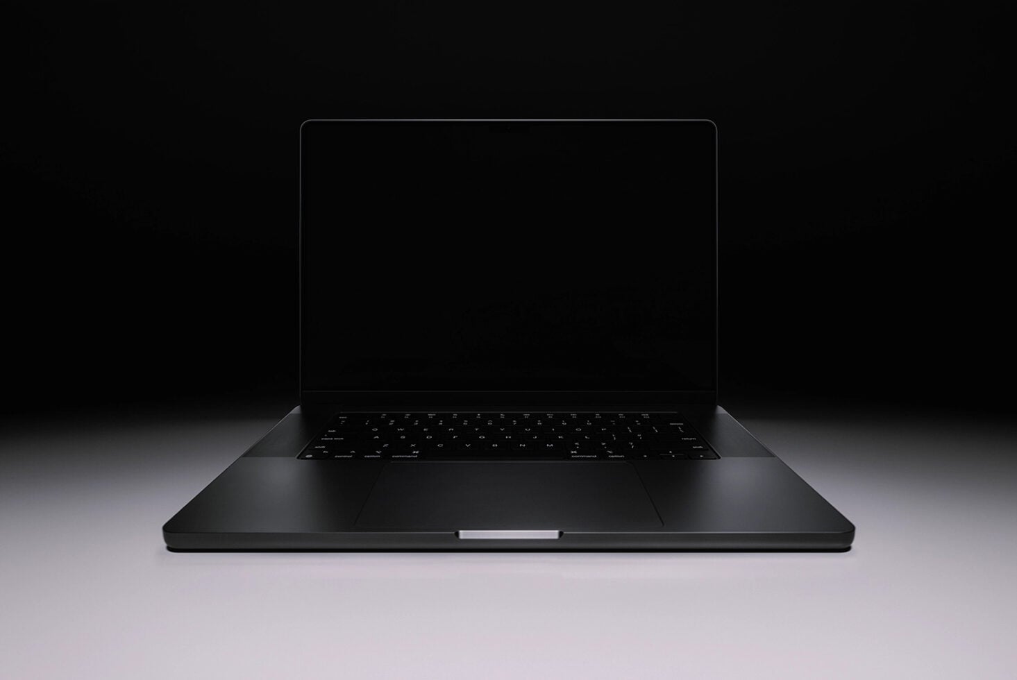 Sleek black laptop mockup with blank screen on dark background, angled view