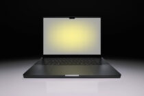 Black laptop mockup with glowing screen on dark background