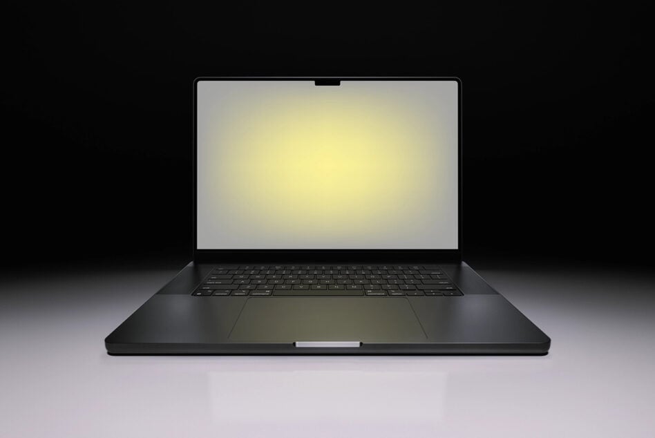 Black laptop mockup with glowing screen on dark background