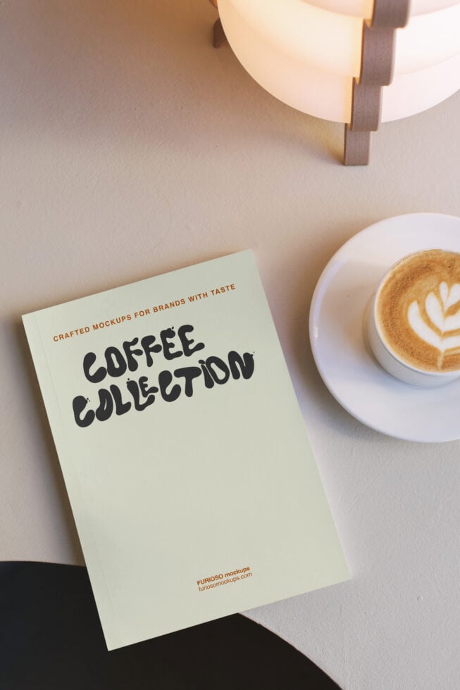 Cream colored poster with bold black text reading "Coffee Collection" next to latte with latte art, warm lighting overhead