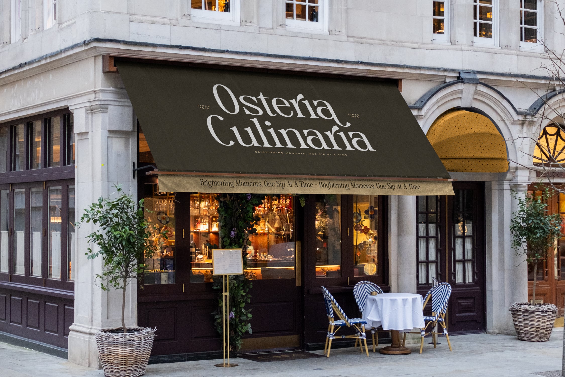 Upscale restaurant storefront with olive awning, white marble facade, bistro seating