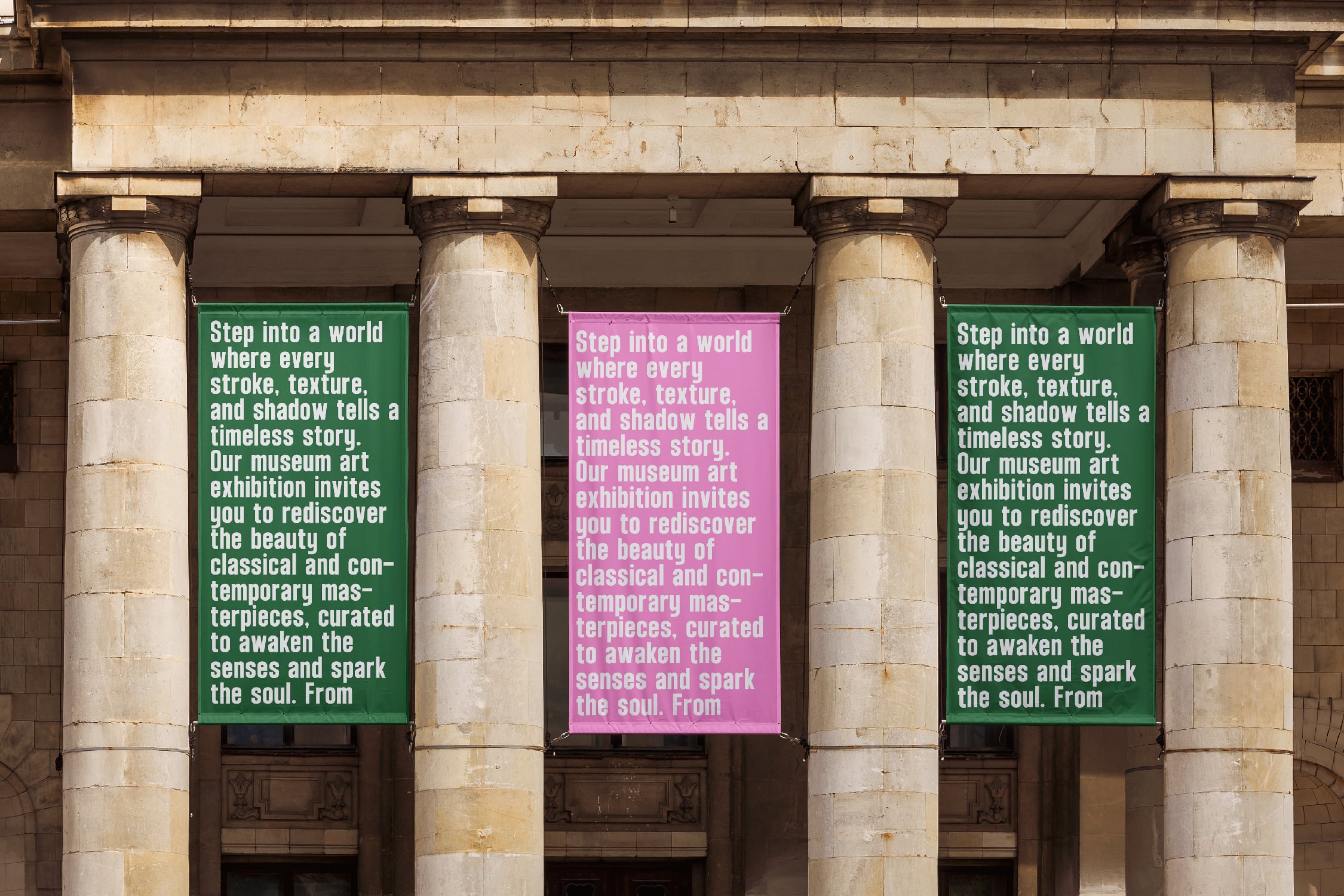 Museum banners hanging on classical stone columns with green, pink text about art exhibition
