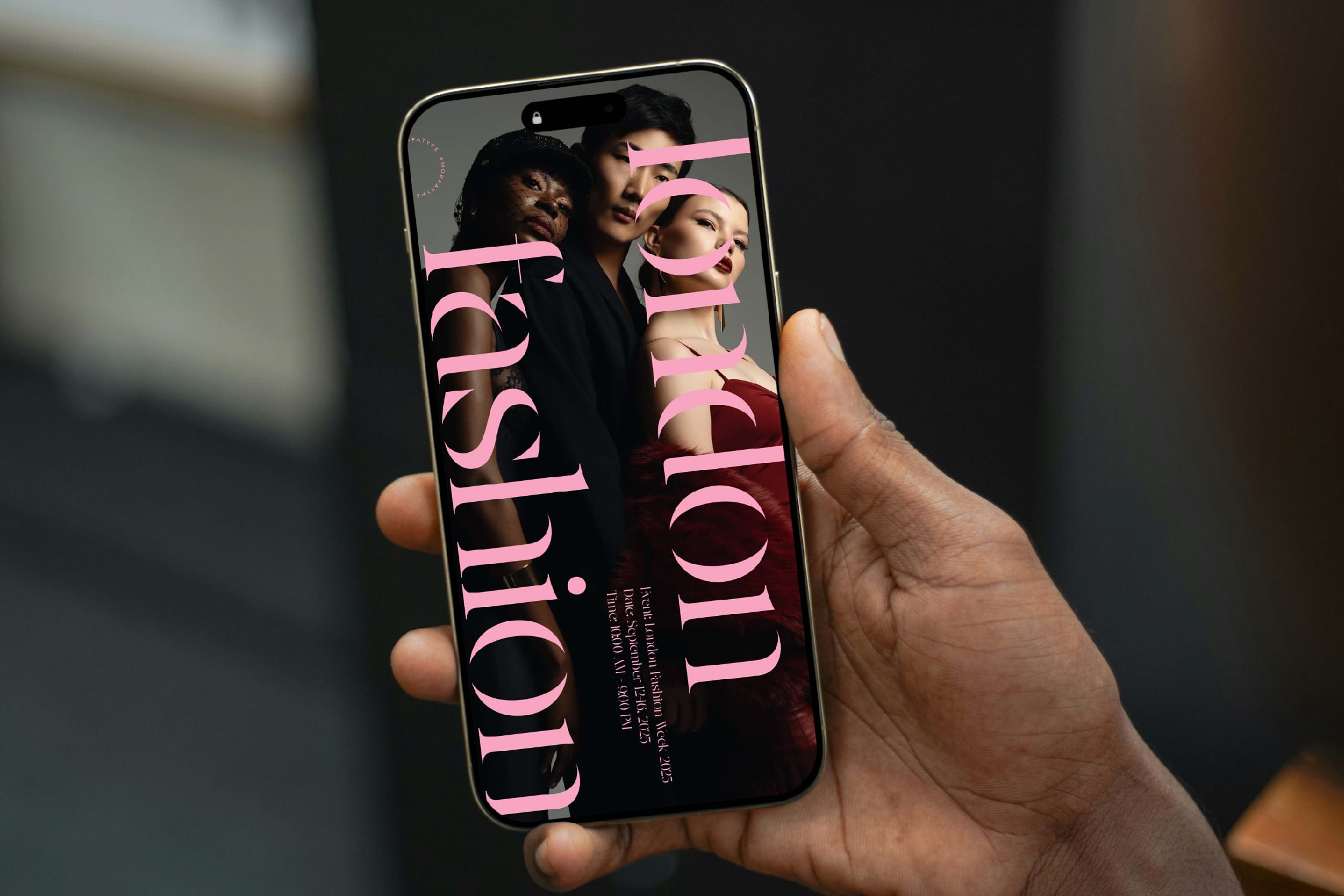 Hand holding phone displaying bold pink typography over fashion photo mockup