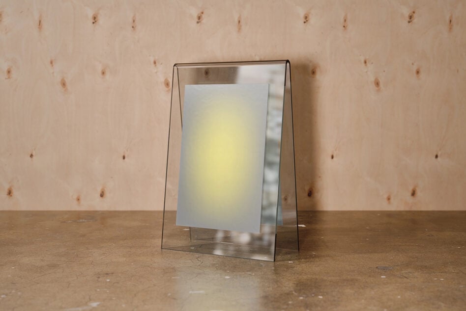 Glass tent card mockup with cream paper insert on textured wood surface
