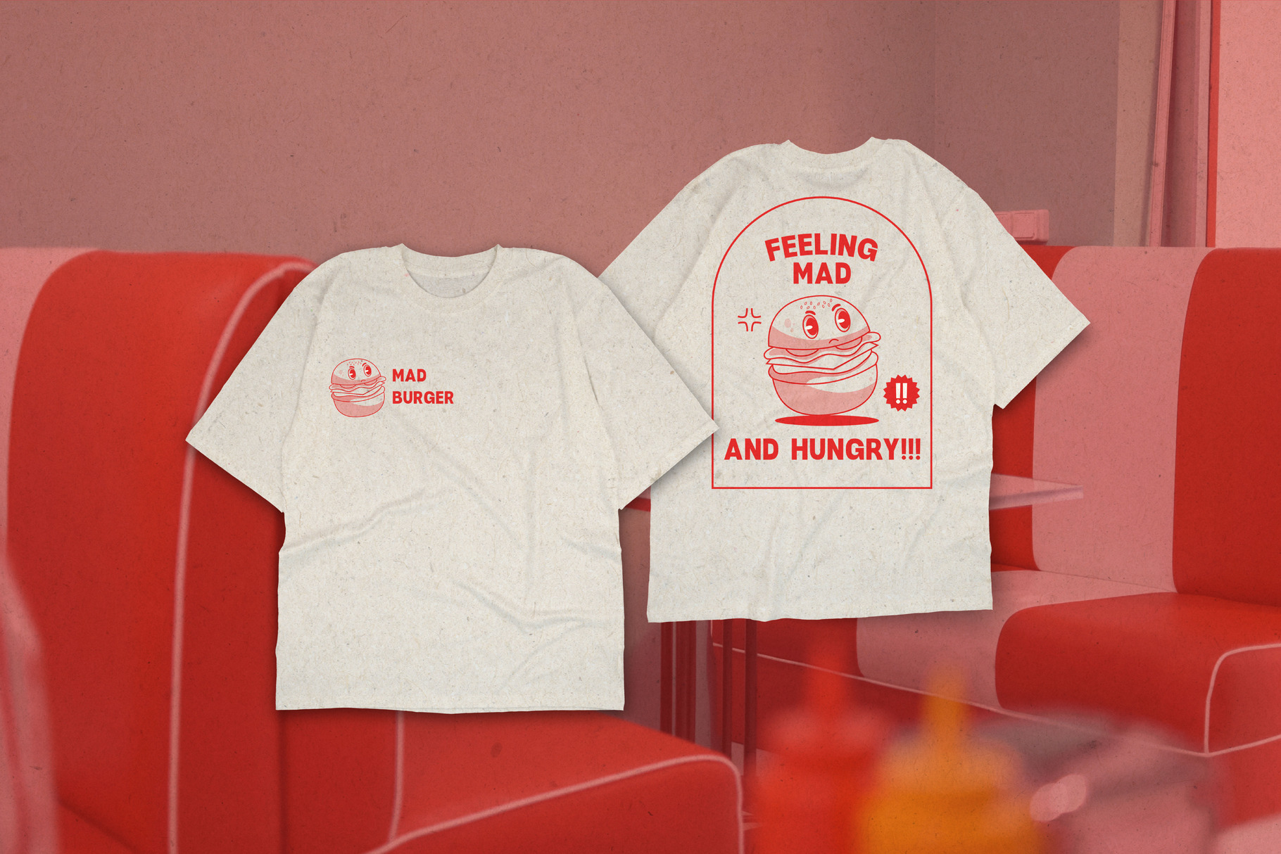 Cream tees with red burger graphics on red couch, one says "Mad Burger" other reads "Feeling Mad Hungry"