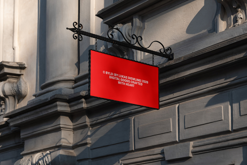 Bright red horizontal storefront sign hanging from ornate black metal bracket on stone building facade
