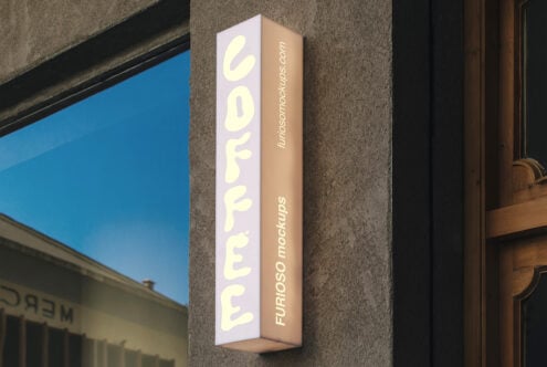 Vertical corner storefront sign with cream neon lettering on pink, tan sides mounted on textured gray wall