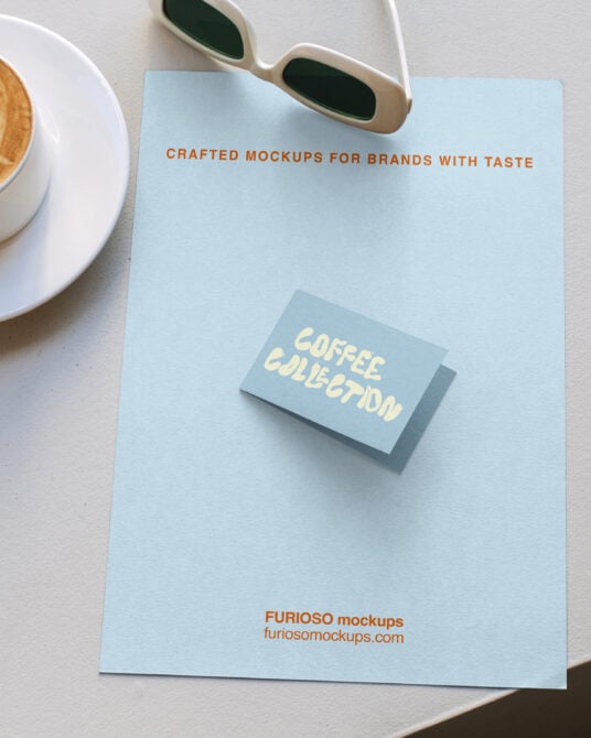 Business card mockup on light blue paper with coffee cup styling