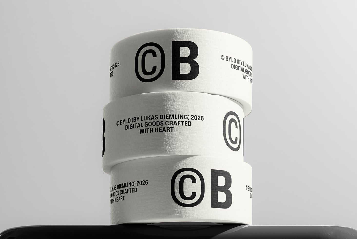 Stacked white packing tape rolls with bold CB logo branding, copyright text wrapping around in minimalist black typography