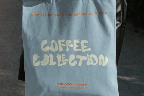 Light blue tote bag mockup with cream text reading "coffee collection" in chunky vintage lettering
