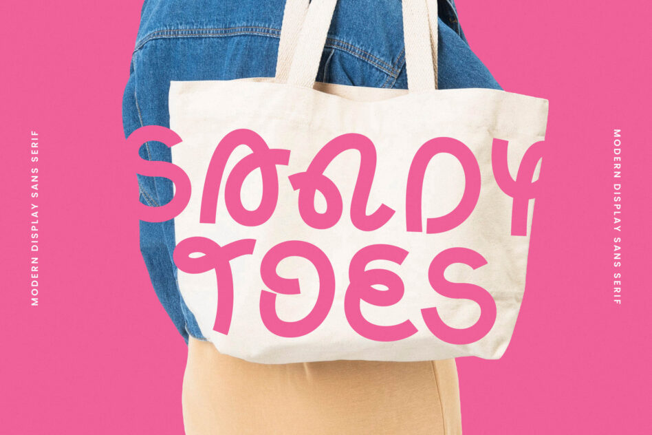 Cream canvas tote bag with bold pink numbers displayed on model wearing denim jacket against hot pink background