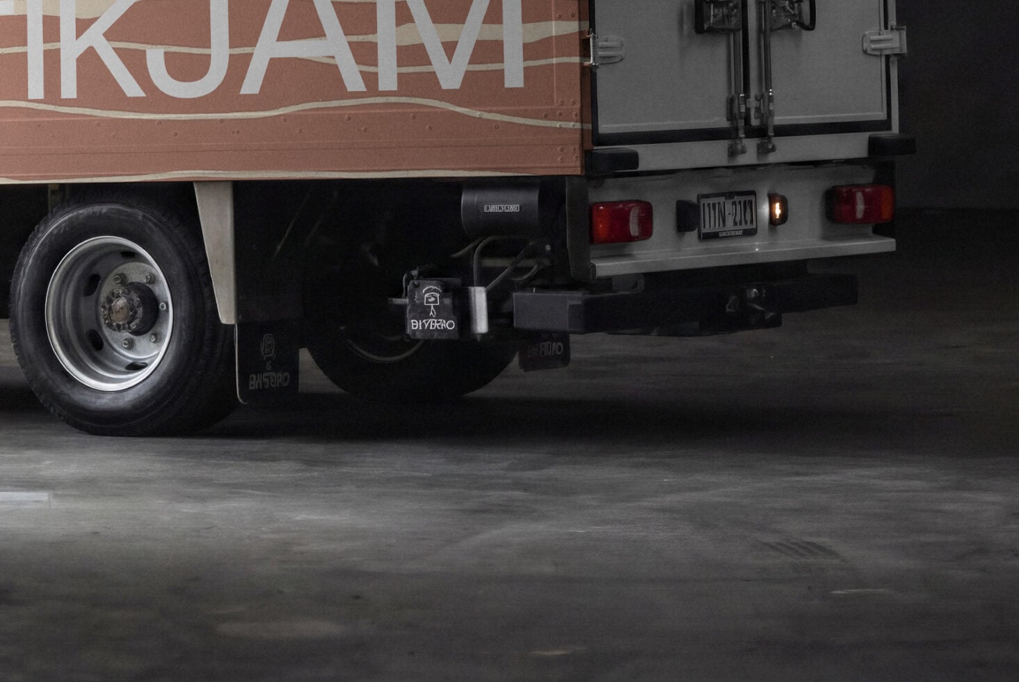 Food truck rear end detail shot with wheel, lights, hitch hardware