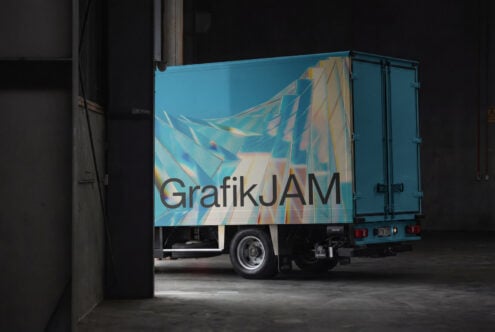 Delivery truck mockup with blue side panel in industrial garage space