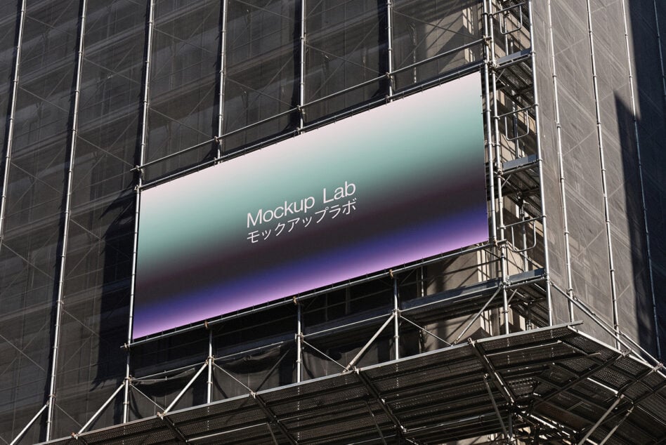 Large billboard on construction scaffolding displaying gradient design with Mockup Lab branding text