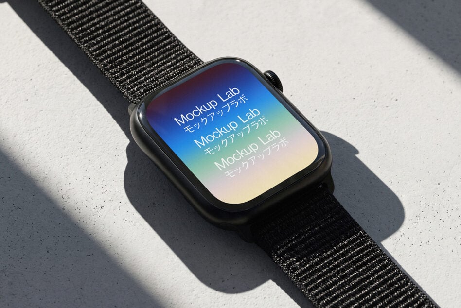 Smartwatch with black sport band on concrete, gradient screen showing colorful mockup text with natural shadow