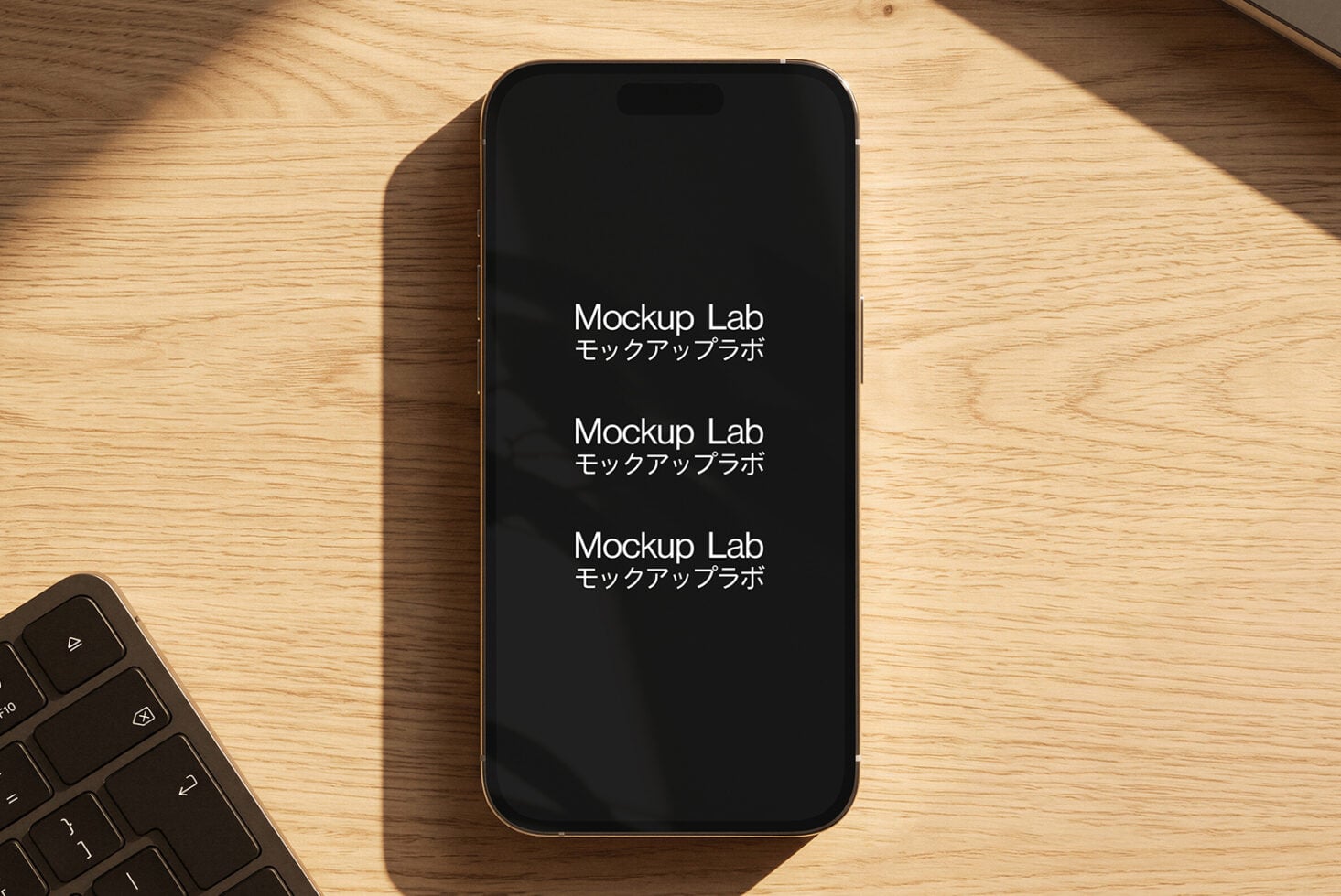 Gold iPhone on wood desk with keyboard, screen showing repeated text in English with Japanese subtitles