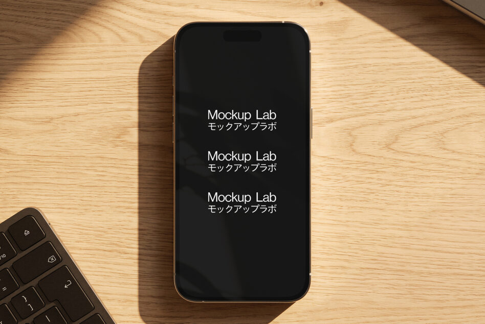 Gold iPhone on wood desk with keyboard, screen showing repeated text in English with Japanese subtitles