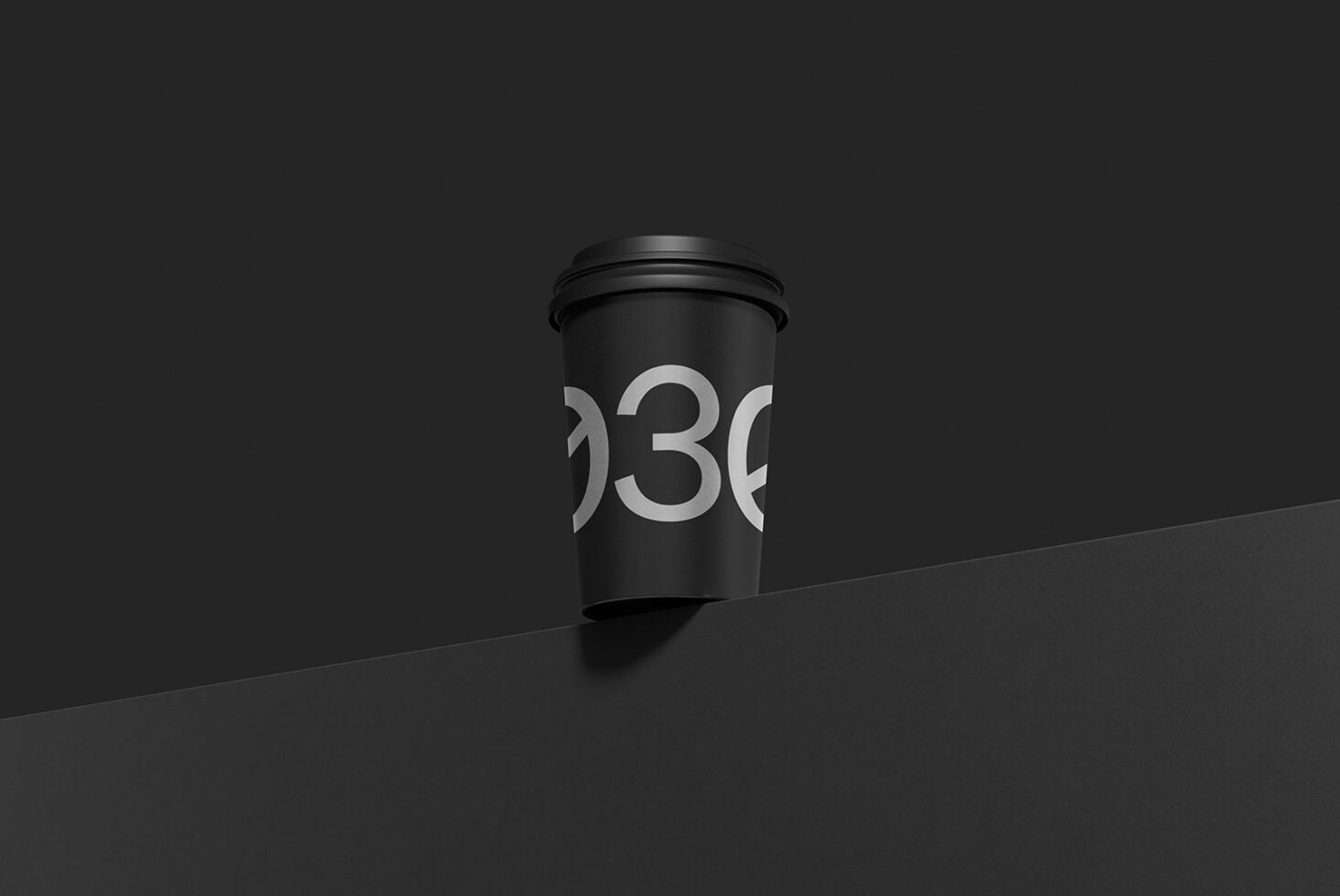 Black coffee cup mockup with silver number design on dark minimalist background