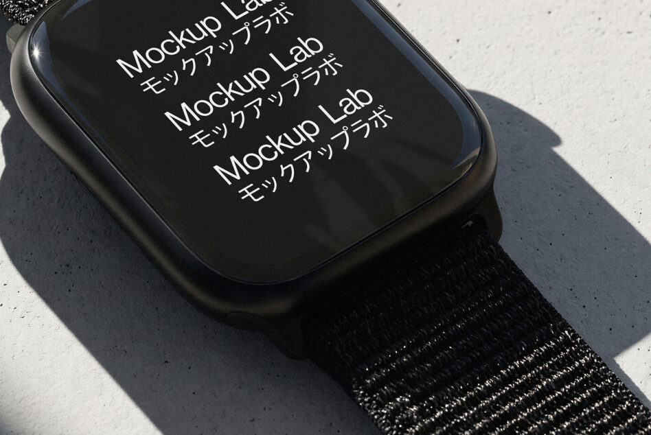 Smartwatch mockup on black fabric band with concrete background, sharp shadows from natural light