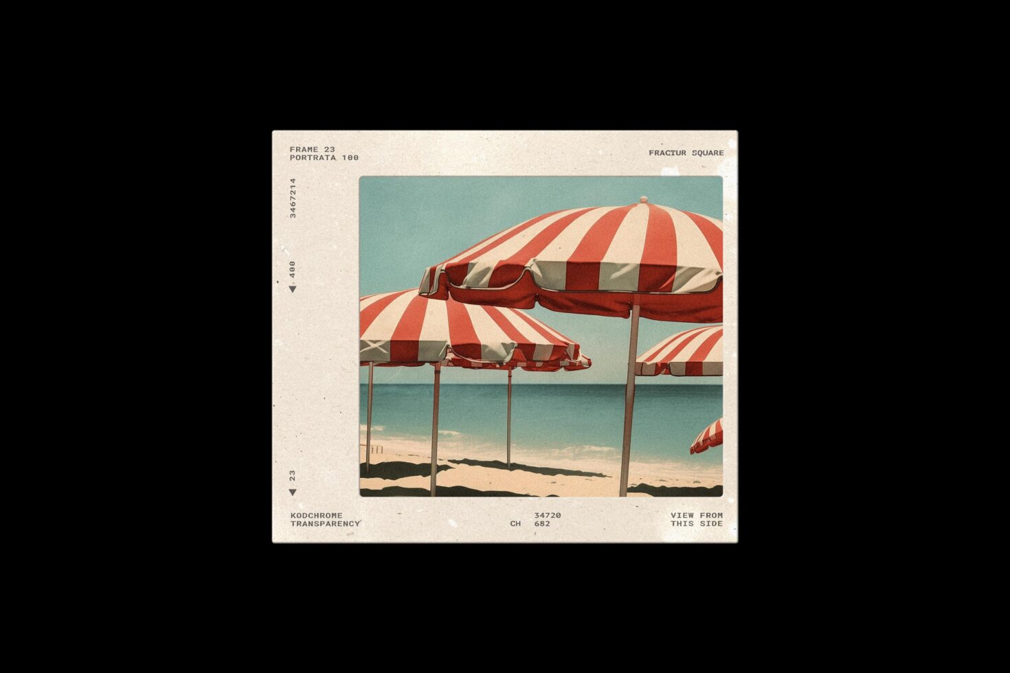 Vintage film slide showing red striped beach umbrellas on sandy shore with turquoise water